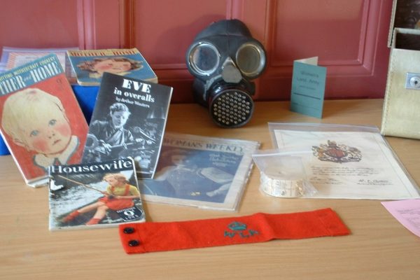 Collection of Items used in our World War II workshop including a gas mask and ration book