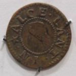 Bronze trade token with the letters 'Alce Lant' on the outside