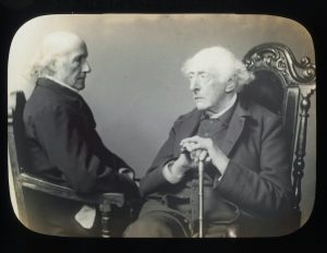 19th century black and white photograph of two men seated facing each other
