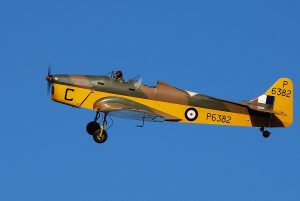 a photograph of a yellow plane