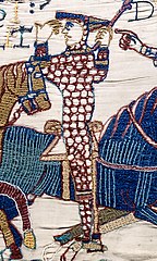 tapestry of soldier on horse with another horse in the background