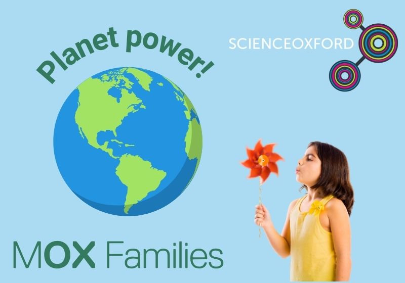 A young girl with brown hair and a yellow top blows a orange paper windmill. A picture of the Earth is surrounded by the text: 'Planet Power!'. The MOX Families logo is in green and the Science Oxford logo is in white.
